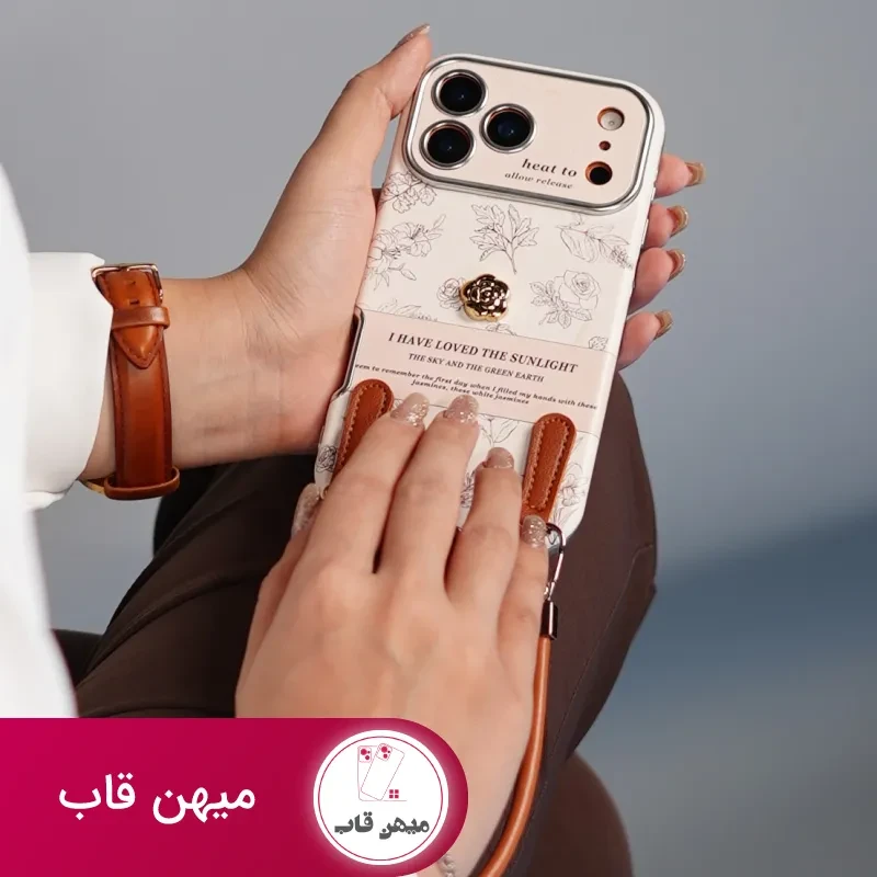قاب موبایل آیفون گل طلایی انگلیسی الگانس محافظ لنزدار + بندست چرمی